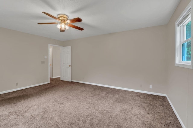 unfurnished room with ceiling fan, carpet floors, and baseboards