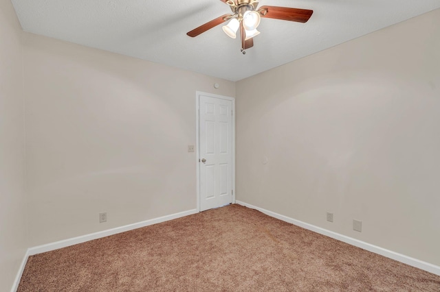 unfurnished room with carpet flooring, baseboards, and ceiling fan