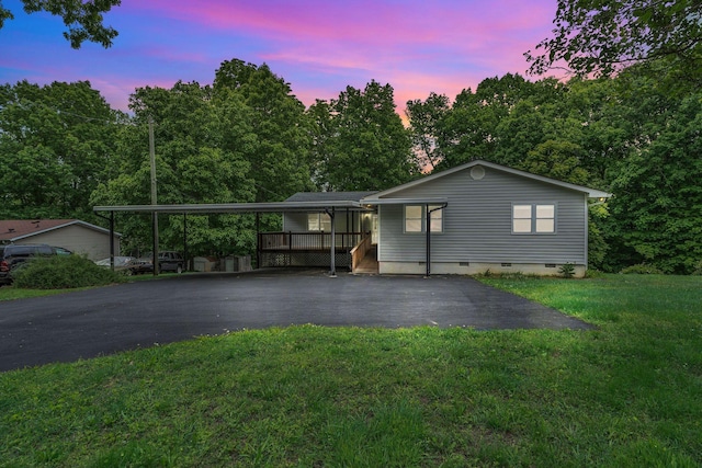 view of front facade featuring asphalt driveway, crawl space, and a front lawn