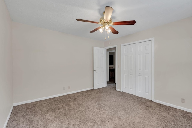 unfurnished bedroom with carpet flooring, a closet, and baseboards