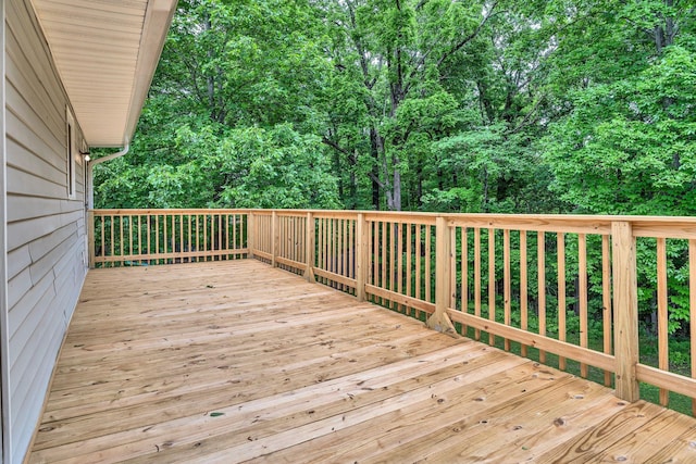 wooden terrace with a wooded view