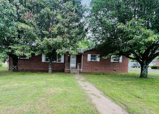 999 Mill St, Pulaski, TN 38478 - view of front of home with crawl space, a front yard, and brick siding