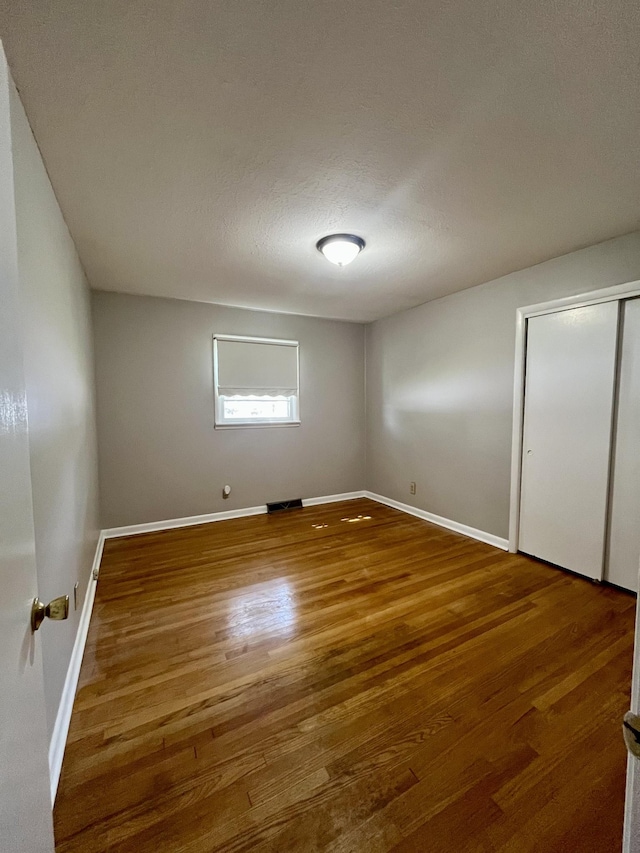 999 Mill St, Pulaski, TN 38478 - unfurnished bedroom with wood finished floors, baseboards, and a closet