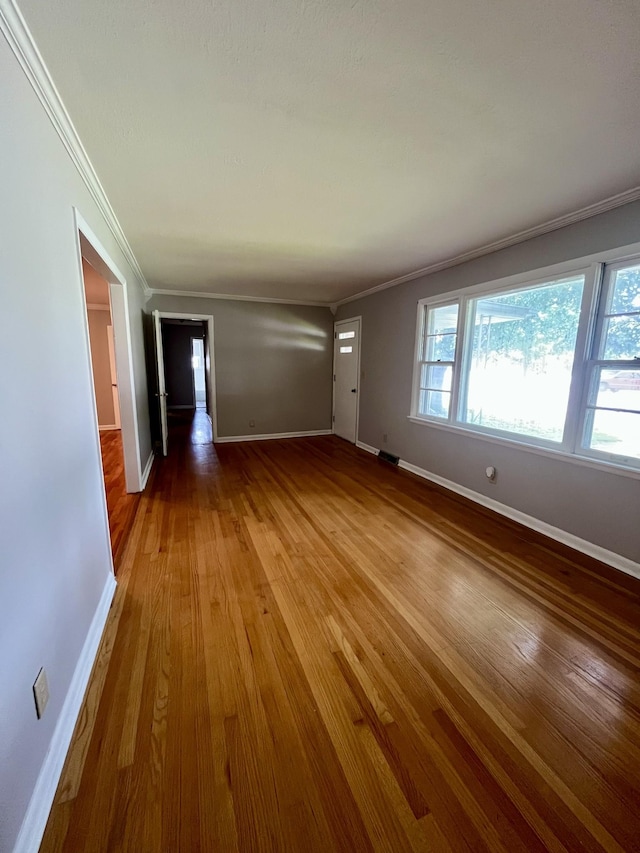 999 Mill St, Pulaski, TN 38478 - unfurnished living room featuring crown molding, wood-type flooring, and baseboards