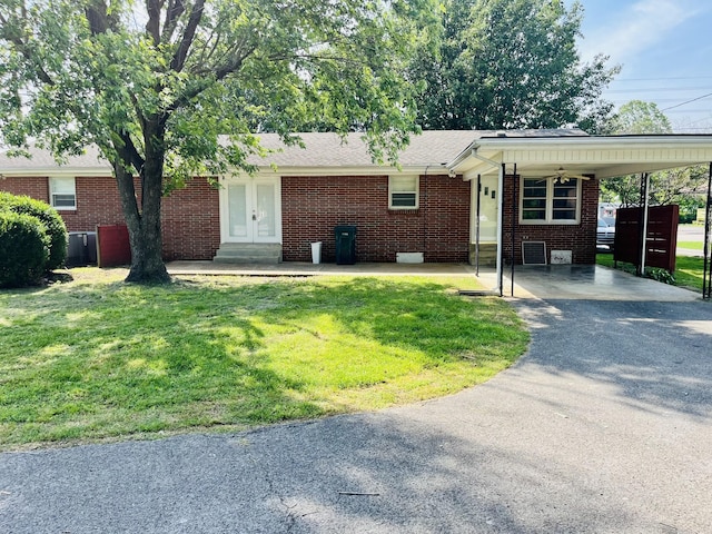999 Mill St, Pulaski, TN 38478 - ranch-style house featuring driveway, french doors, a front lawn, and an attached carport