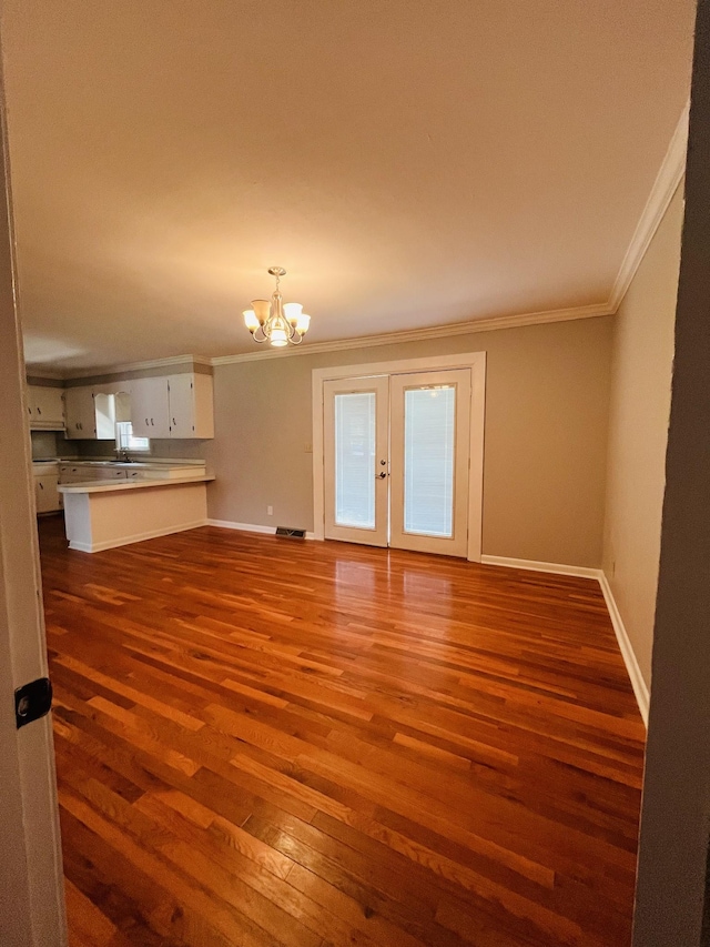 999 Mill St, Pulaski, TN 38478 - unfurnished living room featuring crown molding, a chandelier, dark wood-style floors, baseboards, and french doors