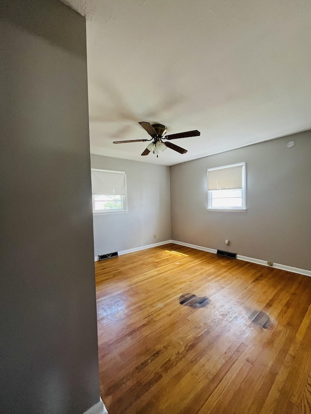 999 Mill St, Pulaski, TN 38478 - spare room featuring plenty of natural light, light wood finished floors, ceiling fan, and baseboards