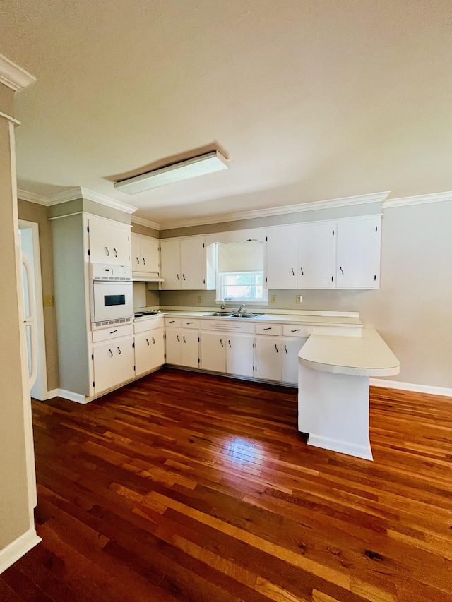 999 Mill St, Pulaski, TN 38478 - kitchen with oven, a sink, dark wood-style floors, crown molding, and baseboards