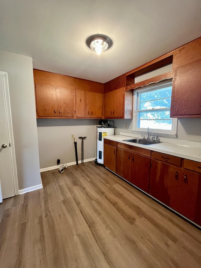 999 Mill St, Pulaski, TN 38478 - kitchen with a sink, brown cabinetry, light wood-style floors, light countertops, and refrigerator