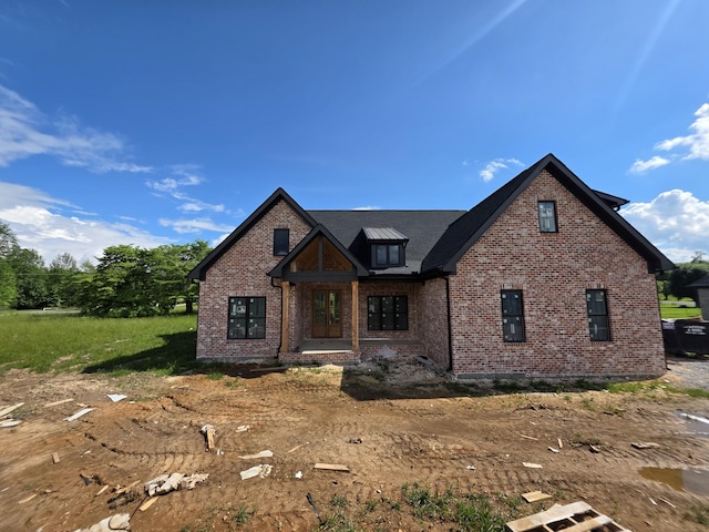 view of front of house featuring brick siding and covered porch