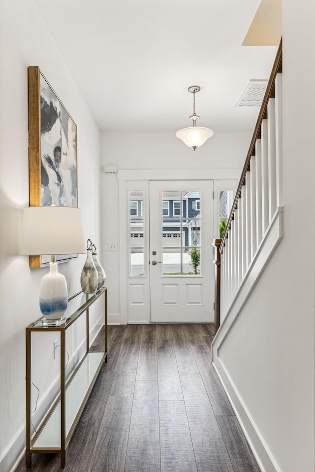 1098 Sweetleaf Dr, Franklin, TN 37064 - foyer entrance with dark wood-type flooring, stairway, and baseboards