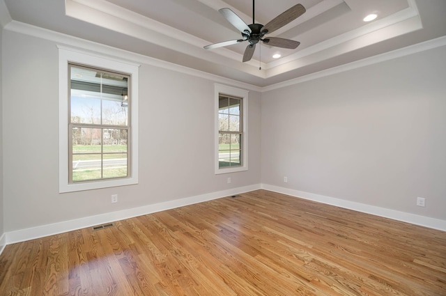 2024 Kestrel Ln, Spring Hill, TN 37174 - spare room with a tray ceiling, crown molding, light wood-style floors, ceiling fan, and baseboards