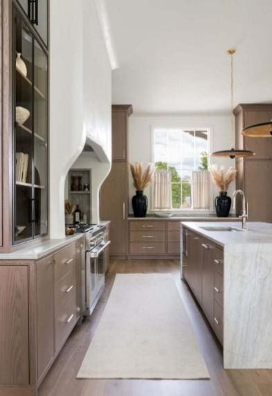 12 Middleton Park Ln, Nashville, TN 37215 - kitchen with a sink, stainless steel range, light wood-style floors, and pendant lighting