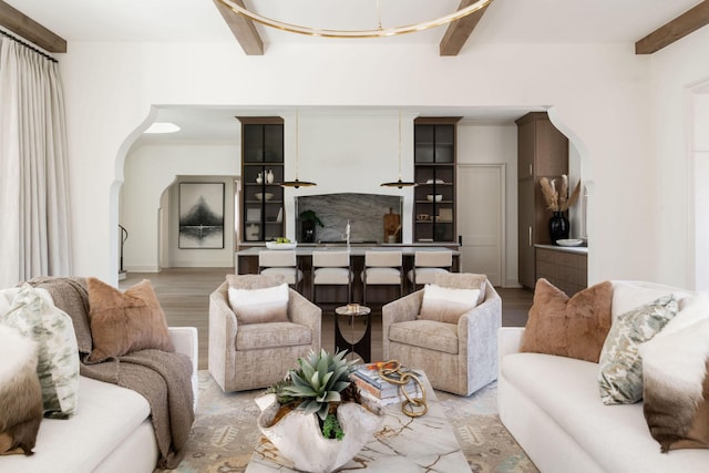12 Middleton Park Ln, Nashville, TN 37215 - living room with arched walkways, beamed ceiling, and light wood-style flooring
