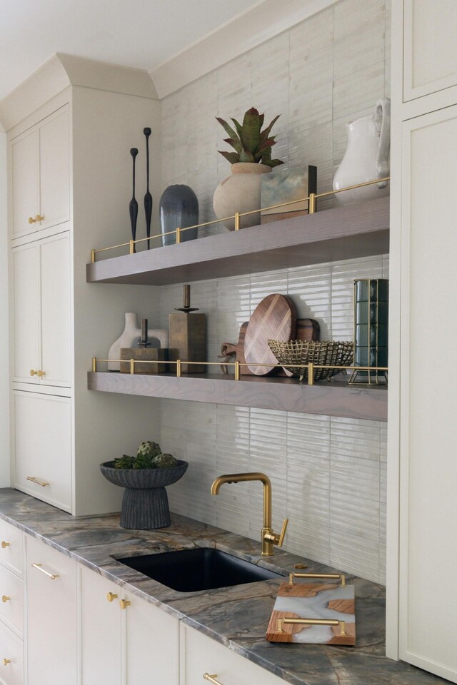 12 Middleton Park Ln, Nashville, TN 37215 - detailed view of a sink, backsplash, white cabinetry, and stone countertops
