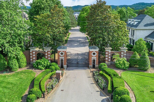 12 Middleton Park Ln, Nashville, TN 37215 - view of front of home featuring a gate, brick siding, a mountain view, and asphalt driveway