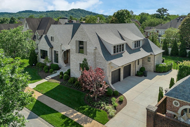 12 Middleton Park Ln, Nashville, TN 37215 - french country inspired facade featuring stone siding, concrete driveway, an attached garage, and a shingled roof
