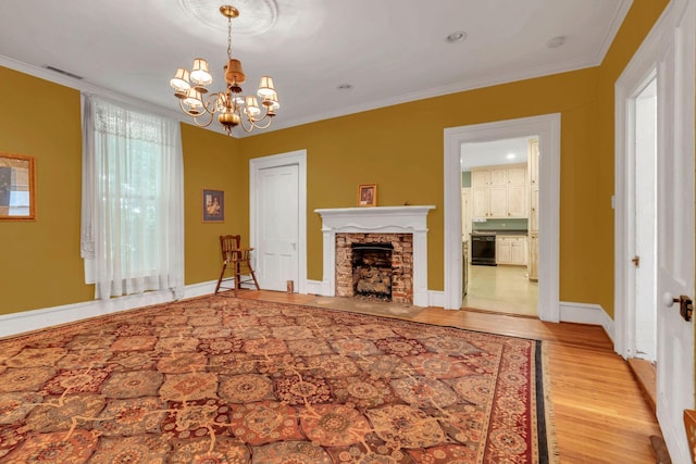 2033 Carters Creek Pike, Franklin, TN 37064 - living room featuring a chandelier, light wood-type flooring, crown molding, a stone fireplace, and baseboards