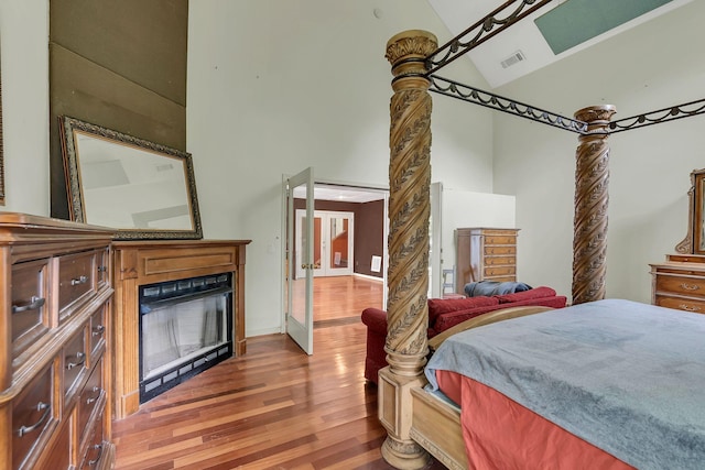 2033 Carters Creek Pike, Franklin, TN 37064 - bedroom with high vaulted ceiling, wood finished floors, and a glass covered fireplace