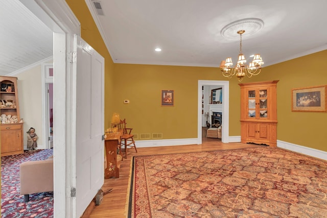 2033 Carters Creek Pike, Franklin, TN 37064 - dining space featuring light wood-style floors, crown molding, a chandelier, baseboards, and a fireplace