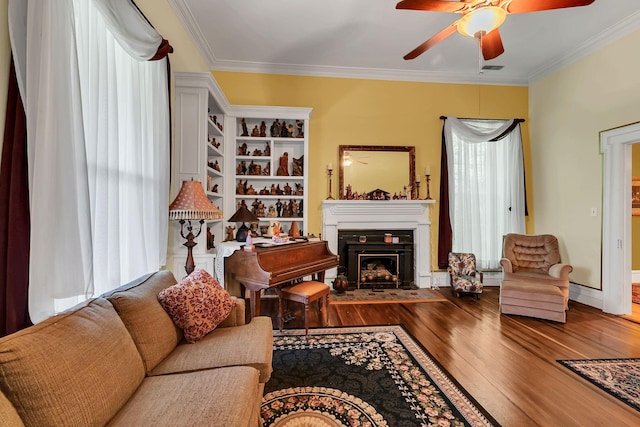 2033 Carters Creek Pike, Franklin, TN 37064 - living room featuring ceiling fan, hardwood / wood-style flooring, ornamental molding, a fireplace with flush hearth, and a baseboard radiator