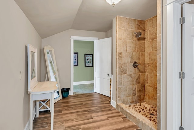 2033 Carters Creek Pike, Franklin, TN 37064 - bathroom featuring a tile shower, wood finished floors, vaulted ceiling, and baseboards