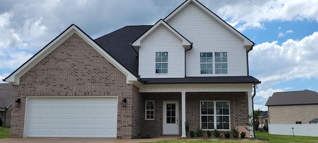view of front facade with brick siding, driveway, covered porch, and an attached garage