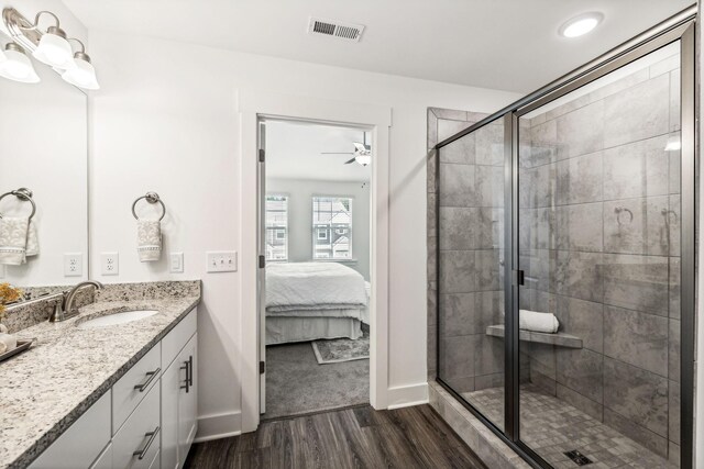 1115 Sweetleaf Dr, Franklin, TN 37064 - bathroom with wood finished floors, baseboards, a shower stall, vanity, and ensuite bathroom