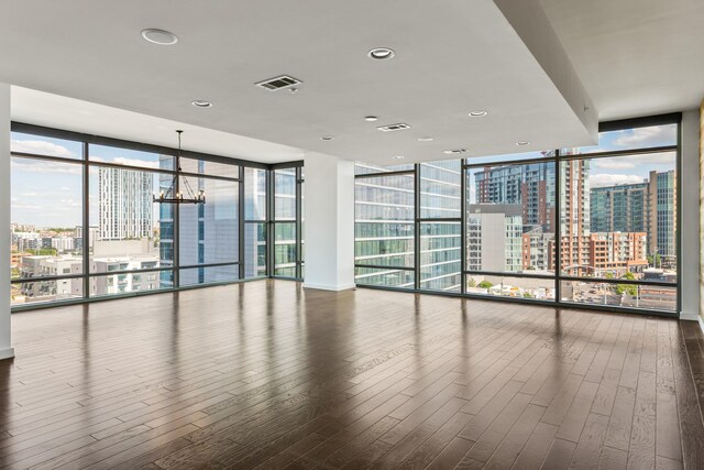 1212 Laurel St Unit 701, Nashville, TN 37203 - spare room featuring a wall of windows, a view of city, hardwood / wood-style floors, and a chandelier
