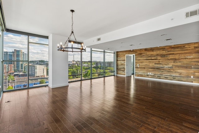 1212 Laurel St Unit 701, Nashville, TN 37203 - spare room with expansive windows, wooden walls, a chandelier, a city view, and plenty of natural light