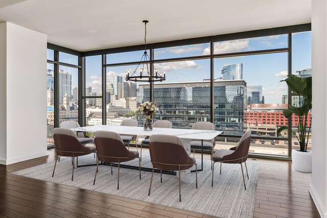 1212 Laurel St Unit 701, Nashville, TN 37203 - dining space with a skyline view, wood-type flooring, a chandelier, a wall of windows, and baseboards