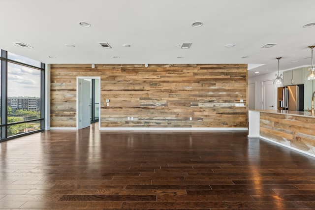 1212 Laurel St Unit 701, Nashville, TN 37203 - unfurnished living room with wooden walls, hardwood / wood-style flooring, expansive windows, recessed lighting, and baseboards