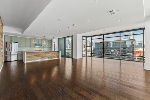 1212 Laurel St Unit 701, Nashville, TN 37203 - unfurnished living room with dark wood-style floors, a wall of windows, recessed lighting, and a sink