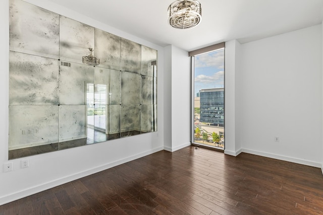 1212 Laurel St Unit 701, Nashville, TN 37203 - empty room with hardwood / wood-style floors, baseboards, and a chandelier