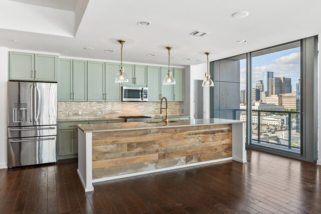 1212 Laurel St Unit 701, Nashville, TN 37203 - kitchen featuring stainless steel appliances, a sink, dark wood-style floors, tasteful backsplash, and expansive windows