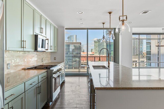 1212 Laurel St Unit 701, Nashville, TN 37203 - kitchen featuring appliances with stainless steel finishes, a sink, plenty of natural light, backsplash, and a wall of windows
