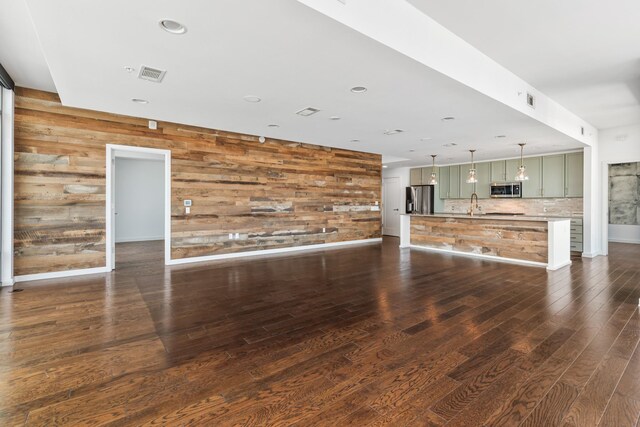 1212 Laurel St Unit 701, Nashville, TN 37203 - unfurnished living room with wood walls, dark wood finished floors, a sink, baseboards, and recessed lighting