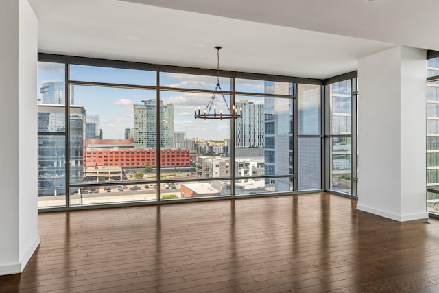 1212 Laurel St Unit 701, Nashville, TN 37203 - unfurnished dining area featuring hardwood / wood-style floors, a view of city, baseboards, a chandelier, and a wall of windows
