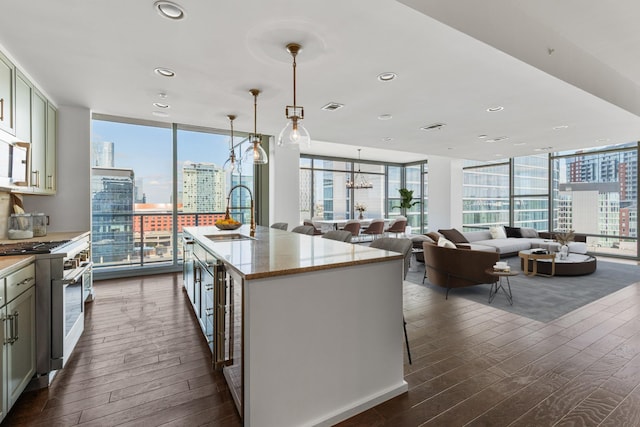 1212 Laurel St Unit 701, Nashville, TN 37203 - kitchen featuring range with gas cooktop, a sink, dark wood finished floors, floor to ceiling windows, and plenty of natural light