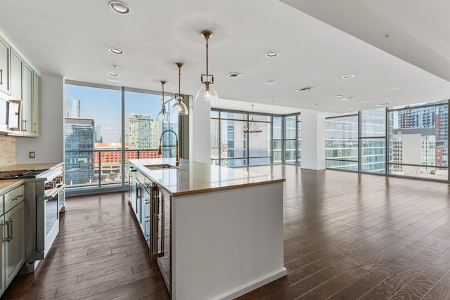 1212 Laurel St Unit 701, Nashville, TN 37203 - kitchen featuring high end range, a sink, expansive windows, dark wood-style floors, and healthy amount of natural light