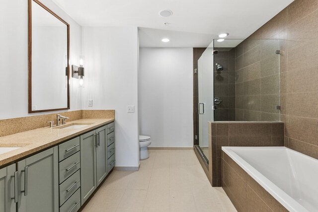 1212 Laurel St Unit 701, Nashville, TN 37203 - full bathroom featuring a stall shower, double vanity, tiled bath, toilet, and recessed lighting