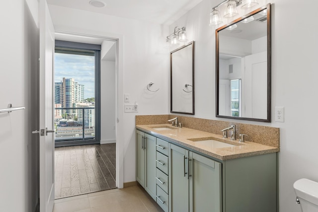 1212 Laurel St Unit 701, Nashville, TN 37203 - bathroom featuring double vanity, toilet, and baseboards