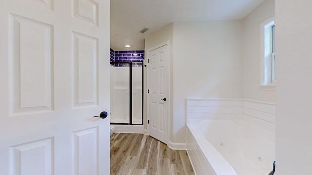 618 Cookstown Dr, Smyrna, TN 37167 - bathroom with a jetted tub, toilet, a shower stall, and wood finished floors