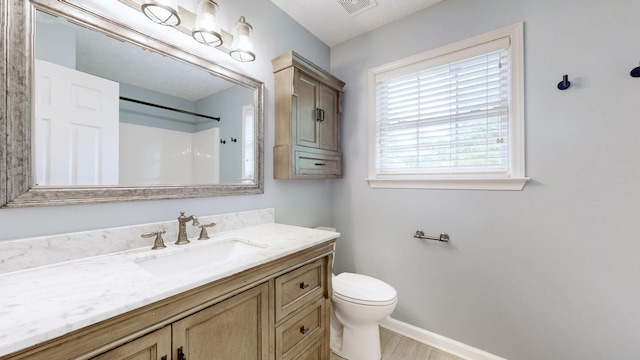618 Cookstown Dr, Smyrna, TN 37167 - bathroom with baseboards, toilet, vanity, a shower, and wood finished floors