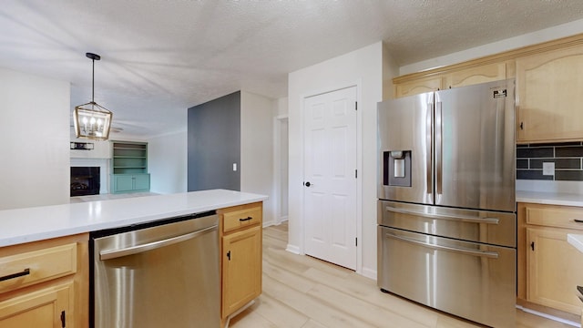 618 Cookstown Dr, Smyrna, TN 37167 - kitchen with appliances with stainless steel finishes, light brown cabinets, light countertops, and a textured ceiling