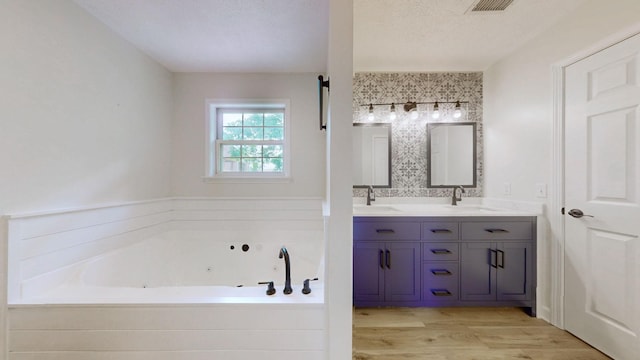 618 Cookstown Dr, Smyrna, TN 37167 - bathroom featuring a jetted tub, wood finished floors, and double vanity