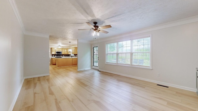 618 Cookstown Dr, Smyrna, TN 37167 - unfurnished living room featuring ceiling fan, a textured ceiling, crown molding, light wood-type flooring, and baseboards