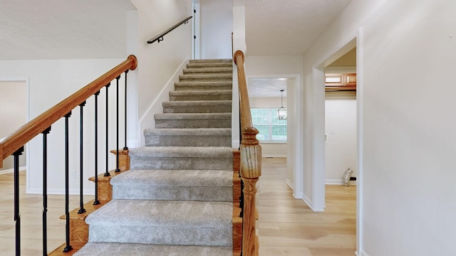 618 Cookstown Dr, Smyrna, TN 37167 - staircase featuring wood finished floors, baseboards, and a textured ceiling