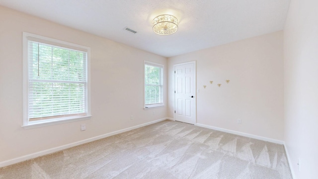 618 Cookstown Dr, Smyrna, TN 37167 - empty room featuring plenty of natural light, light colored carpet, and baseboards