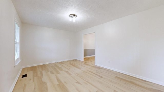 618 Cookstown Dr, Smyrna, TN 37167 - spare room featuring wood finished floors, a textured ceiling, and baseboards